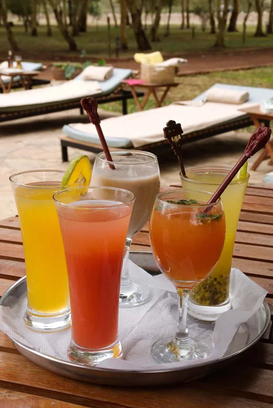A tray of cocktails beside the pool
