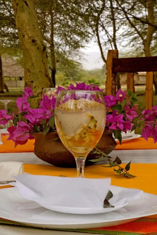 A plated dessert dressed with bougainvillea flowers