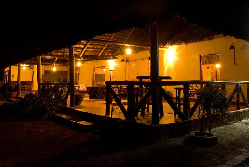 The lodge verandah lit at night